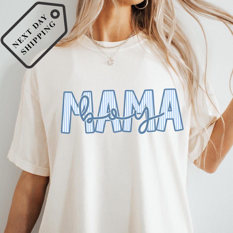 A woman wearing a white t-shirt with the word "MAMA" printed on it.
