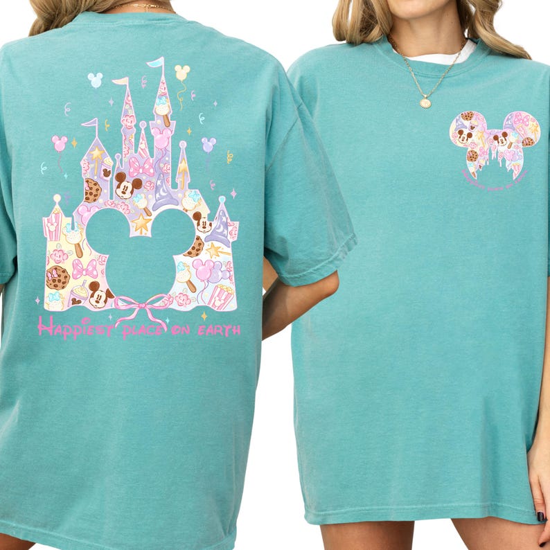 two turquoise t-shirts with Disney-themed designs. The t-shirt on the left has a castle and Mickey Mouse motif, while the t-shirt on the right has a Mickey Mouse motif. Both t-shirts have the text "Happiest place on earth" printed on them.