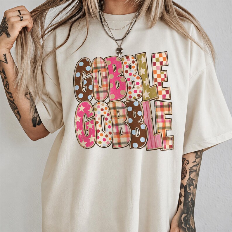 A person wearing a white t-shirt with the text "GOBBLE GOBBLE" printed on it.