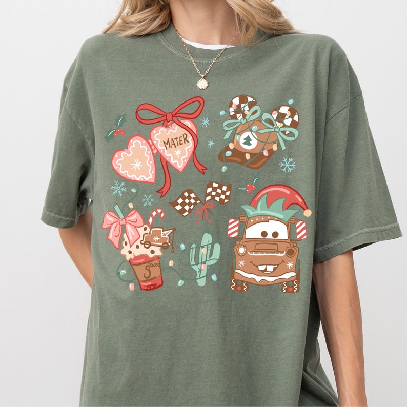 A green t-shirt with a variety of colorful and whimsical illustrations, including characters, objects, and decorative elements.