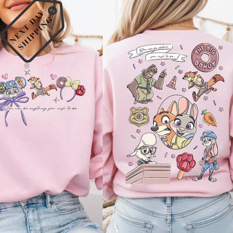 a woman wearing a pink sweatshirt with various cartoon characters and designs on the back.