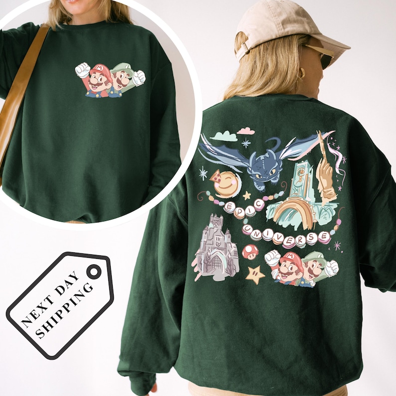 A green sweatshirt with a colorful graphic design featuring Mario and other characters, along with various other elements such as a castle, a dragon, and a rainbow.