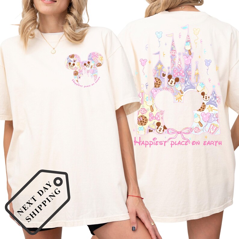 A woman wearing a white t-shirt with a Disney-themed design on the back, including Mickey Mouse and a castle.