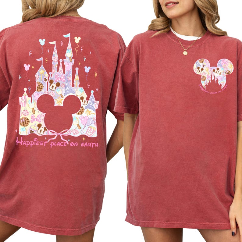 two women wearing red t-shirts with Disney-themed designs. The t-shirts have a castle and Mickey Mouse motif, and the text "Happiest place on Earth" is printed on the back.