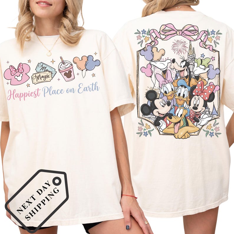 A woman wearing a white t-shirt with a Disney character design on the back.