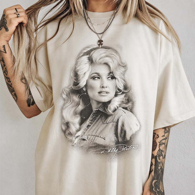 A person wearing a t-shirt with a portrait of a woman printed on it.