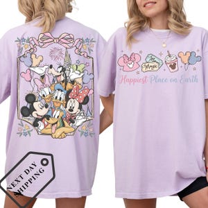 a woman wearing a purple t-shirt with a Disney character design on the back.