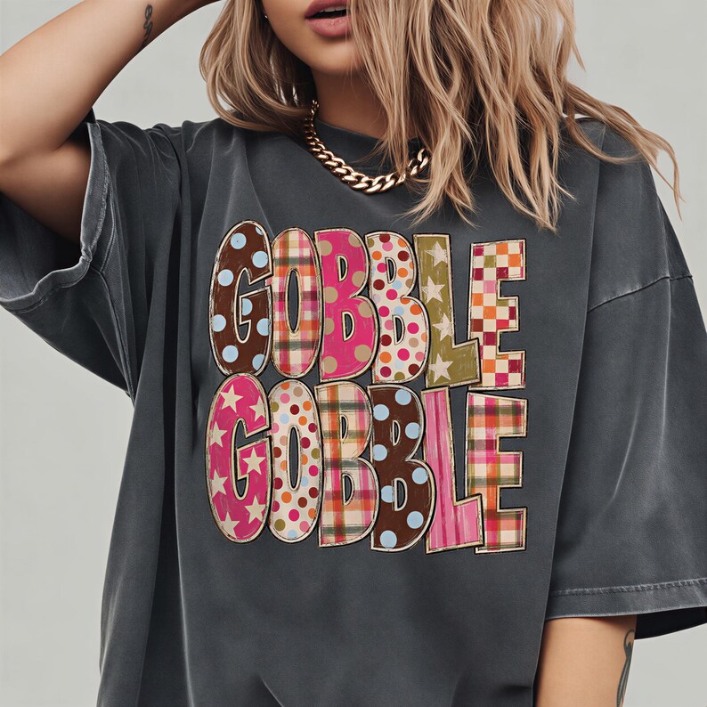 A woman wearing a gray t-shirt with the text "GOBBLE GOBBLE" printed on it.
