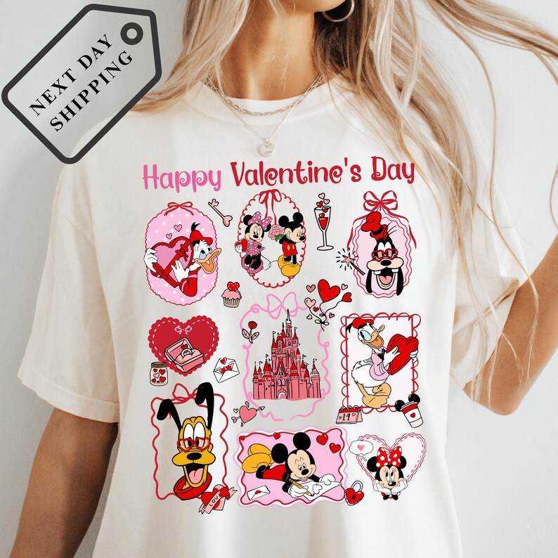 A white t-shirt with a collage of various Disney characters and elements, including Mickey Mouse, Minnie Mouse, Goofy, and other iconic Disney characters, along with a castle and hearts. The text "Happy Valentine's Day" is displayed above the characters.