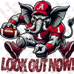 May include: A cartoon elephant wearing a red and white football uniform with the number "1" on the front and a red baseball cap with a white "A" on it. The elephant is holding a football and has a determined look on its face. The text "LOOK OUT NOW!" is written in red letters below the elephant.