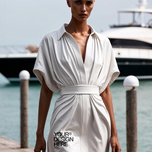 May include: A white collared shirt dress with short sleeves and a cinched waist. The dress has a deep V-neckline and a relaxed fit. The text "YOUR&reg; DESIGN HERE" is printed on the front of the dress.