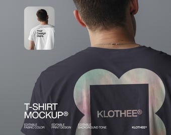 May include: A navy blue t-shirt mockup featuring a large, iridescent design on the back, with the text "KLOTHEE®". An inset shows a white t-shirt with "Your Design Here" printed on the back. The words "T-SHIRT MOCKUP®" are also visible.