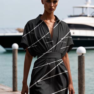 May include: A black and white striped short-sleeved dress with a V-neckline and a belt. The dress is cinched at the waist and has a relaxed fit.
