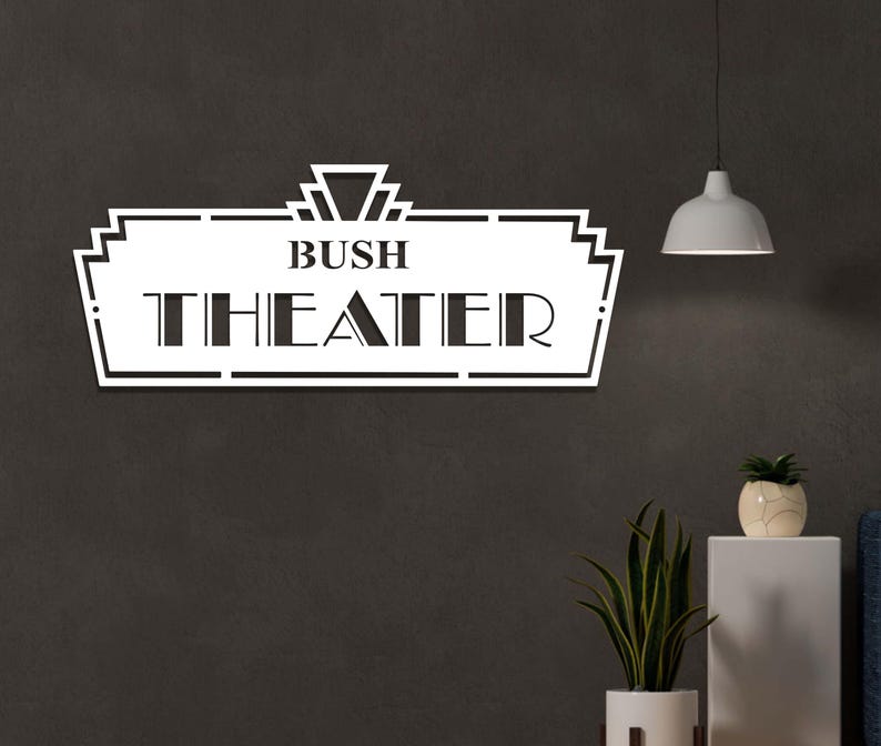 May include: White metal sign with a black art deco design. The sign reads "Bush Theater".