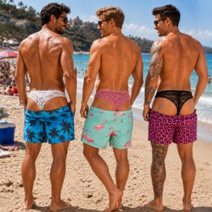 May include: Three pairs of swim shorts worn with lace thongs. The first pair is blue with black palm trees, the second is light green with pink flamingos, and the third is pink with a black leopard print pattern. Each pair features a drawstring.