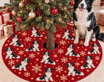 May include: A round red Christmas tree skirt featuring a repeating pattern of black and white Border Collie dogs and gold snowflake icons. The fabric mat is positioned on the floor beneath a decorated pine tree with a dog sitting nearby.