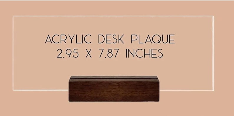 May include: A rectangular clear acrylic desk plaque with a dark brown wooden base. The plaque features the black text ACRYLIC DESK PLAQUE 2.95 X 7.87 INCHES printed on the surface. The item is displayed against a solid light tan background.