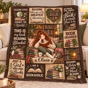 May include: A brown throw blanket featuring a collage of book-themed illustrations, including a person reading, stacks of books, a cat, and a heart-shaped bookshelf. Text includes 'Reading Books Change The World', 'Book Hoarder', and 'Olivia'.