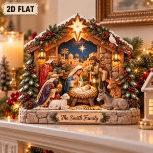 May include: A decorative nativity scene featuring the Holy Family, three wise men, a lamb, a donkey, and a cow inside a stable structure with a star on top. The base includes a plaque with the text The Smith Family. The scene is illuminated with warm lights and decorated with pine branches, pinecones, and red berries.