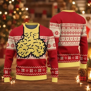 May include: A red long-sleeve knit jumper featuring a yellow graphic of two rounded, textured shapes on the chest. The garment includes a yellow crew neckline, cuffs, and hem, with white horizontal bands displaying snowflake and candy cane patterns.