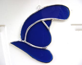 May include: A blue stained glass ornament shaped like a hat with a silver outline.