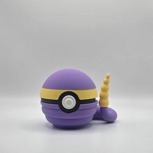 May include: A purple and yellow Poke Ball with a white circle in the center and a yellow horn on the side.