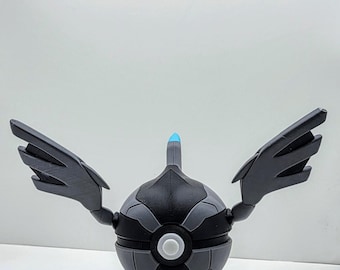 May include: A detailed, 3D-printed model of a black and gray spherical object with wing-like appendages. The object has a blue tip and a white circular detail in the center. The design is geometric and futuristic, set against a white background.