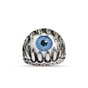 May include: A silver-colored ring featuring a detailed design of an eyeball. The eye has a bright blue iris and a black pupil, set within a white sclera. The ring's band is crafted to resemble a set of teeth, creating a unique and gothic aesthetic.