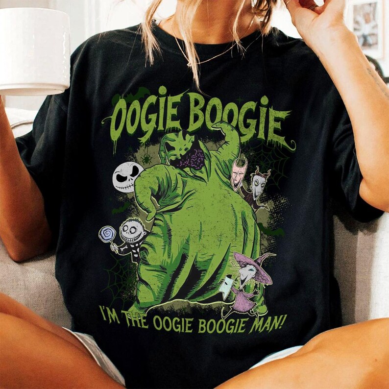 May include: Black t-shirt featuring a green graphic of Oogie Boogie from The Nightmare Before Christmas. The design includes other characters and the text "Oogie Boogie" and "I'm the Oogie Boogie Man!"
