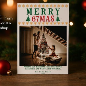 May include: A Christmas card with the text "MERRY 67MAS" in green and red, with a family decorating a Christmas tree. The card also includes the text "Wishing you a holiday filled with love, laughter, and a little bit of chaos."