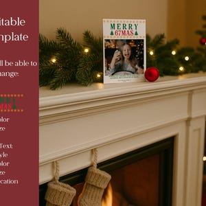 May include: A Christmas card with the text "MERRY 67MAS" and a photo of a person. The card is on a white mantelpiece with a red ornament and evergreen garland. A Christmas tree is in the background.