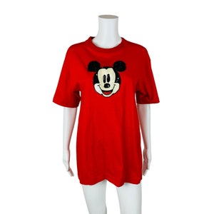 May include: Red short-sleeved t-shirt with a sequined Mickey Mouse face graphic.