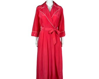May include: A long, pink robe with white piping around the collar, cuffs, and sash. The robe is made of a silky material and has a wrap-around style.