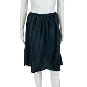 May include: A black slip skirt with a lace trim. The skirt is made of a smooth, silky fabric.