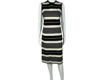 May include: A sleeveless dress with black and white horizontal stripes. The dress is fitted and has a round neckline.