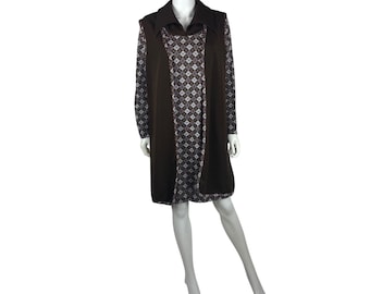 May include: A brown vintage dress with a geometric pattern and long sleeves. The dress features a dark brown vest-like overlay with a wide collar. The dress is displayed on a mannequin.