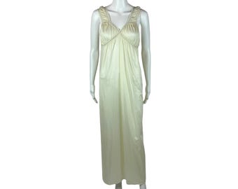 May include: A long, sleeveless, ivory-colored nightgown with a ruffled neckline and a gathered bodice.