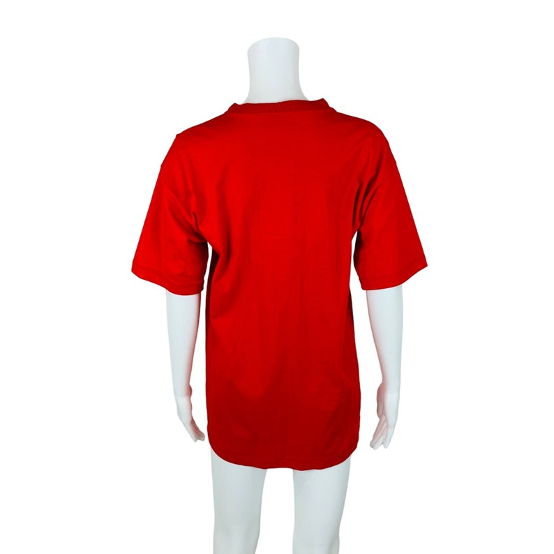May include: A plain red t-shirt on a white mannequin.