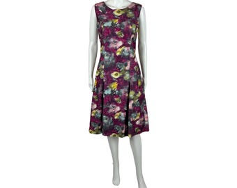 May include: A sleeveless, knee-length dress with a floral print in shades of pink, green, and yellow on a burgundy background. The dress has a fitted bodice and a flared skirt.