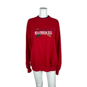 May include: Red sweatshirt with a blue and white embroidered design that says "Get ready for the MILLENNIUM BUG" with a bee, ladybug, butterfly, and dragonfly.