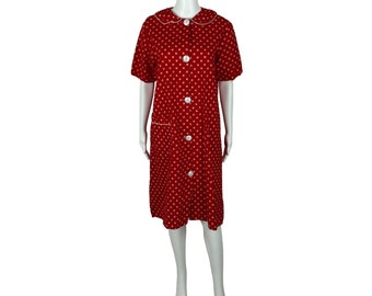 May include: A red dress with white polka dots and a white collar. The dress has short sleeves and a button-up front.
