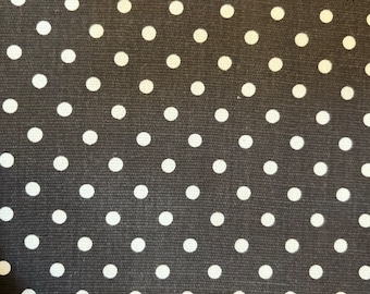 May include: Black fabric with a white polka dot pattern.
