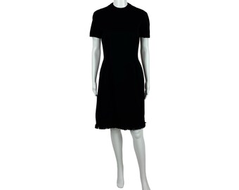 May include: A black short-sleeved dress with a fringe hem.