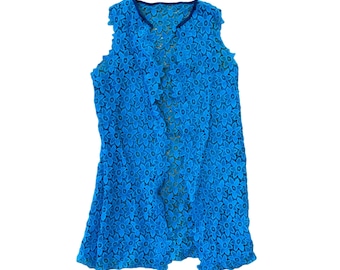 May include: A blue sleeveless lace cardigan with a floral pattern.