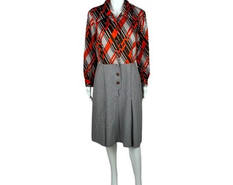 May include: A vintage dress with a geometric print top and a solid gray skirt. The top has a brown, white, and orange geometric pattern. The skirt is a knee-length A-line style.