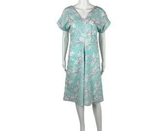 May include: A light blue dress with a white floral print. The dress has a v-neck and short sleeves.