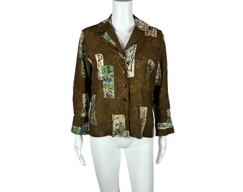 May include: A brown button-up shirt with a long sleeve and a print of Japanese characters and bamboo.