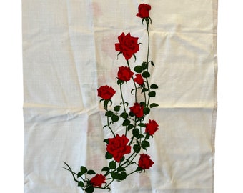 May include: White fabric with a red rose vine design. The roses are red with green leaves and stems.