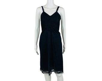 May include: A black slip dress with a lace trim. The dress has a V-neckline and adjustable straps.
