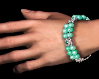 Aqua-green pearl bracelet with silver spacer beads and rhinestones.